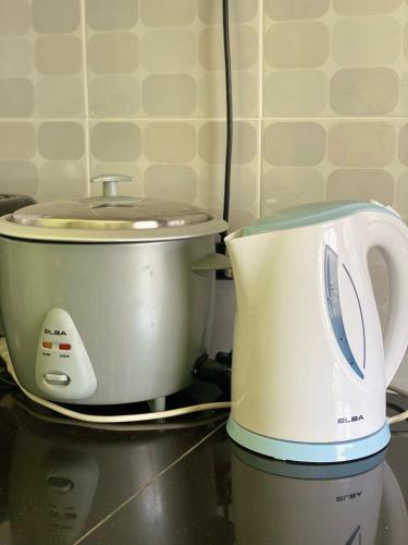 a white toaster sitting on top of a counter at Homestay Desa Tikam batu in Sungai Petani