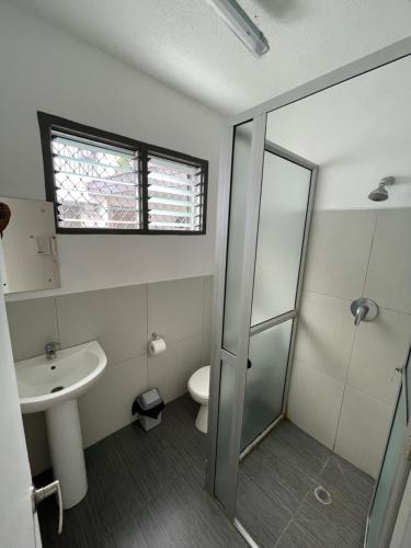 a bathroom with a toilet and a sink and a shower at Island Accommodation Suva Premier Hospitality in Suva