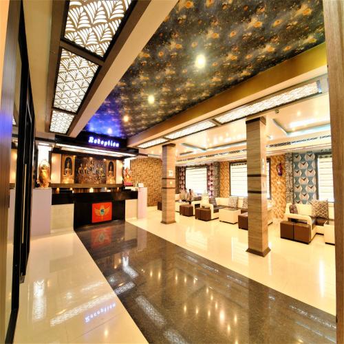 a lobby with couches and a ceiling with stars at Hotel Star Bodh Gaya in Bodh Gaya