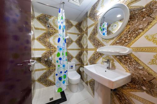 a bathroom with a sink and a mirror at Tanha Hotel in Dubai