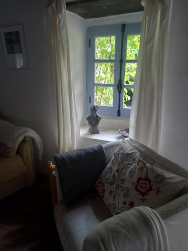 a living room with a couch and a window at Les Trois Noyers in Tailhac