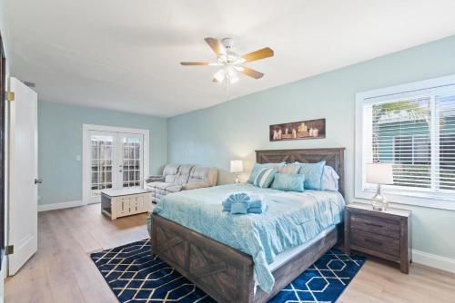 a bedroom with a bed and a ceiling fan at The Redington Beach House in St Pete Beach