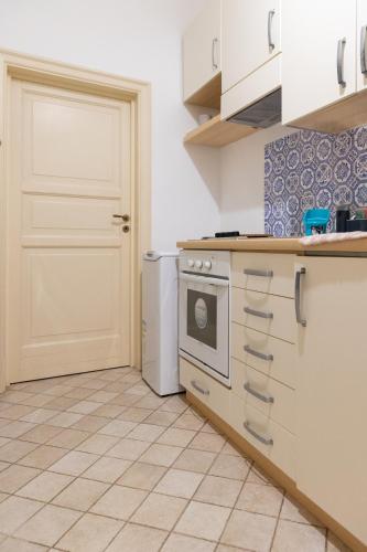 a kitchen with a stove and a refrigerator at Dimora Artale in Cattedrale in Palermo