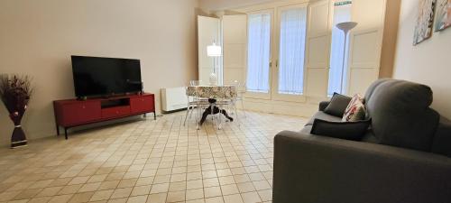 a living room with a flat screen tv and a couch at Dimora Artale in Cattedrale in Palermo