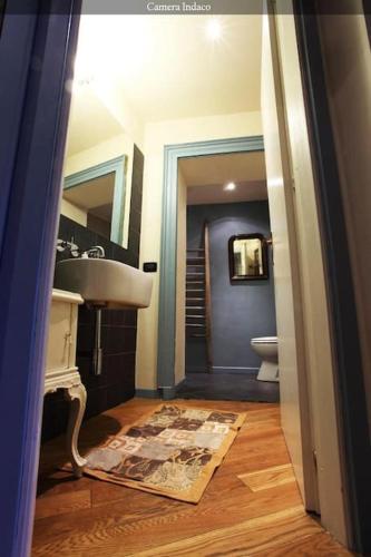 a bathroom with a sink and a toilet at Colazione in Piazza Castello in Turin