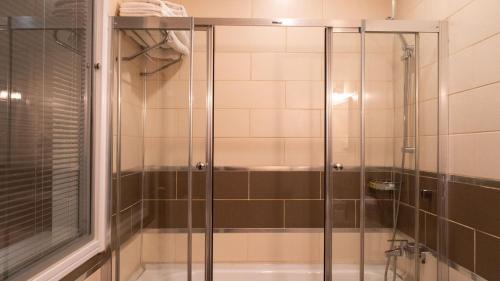 a shower with a glass door in a bathroom at İpek Palas Otel in Urfa