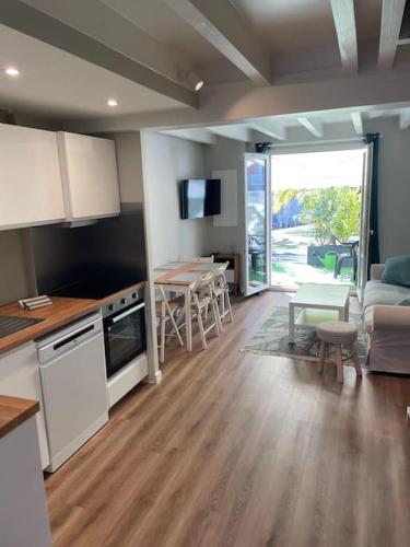 a kitchen and living room with a couch and a table at T3 à anglet limite biarritz in Anglet