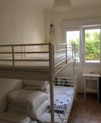 a bedroom with a bunk bed and a window at Cielo Azul in Campoamor