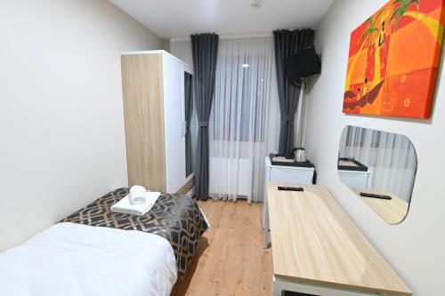 a hotel room with a bed and a desk at Grand Hotel Konuralp in Duzce