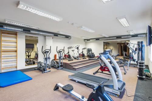 a gym with several treadmills and cardio machines at Førde Hotel - Unike Hoteller in Førde