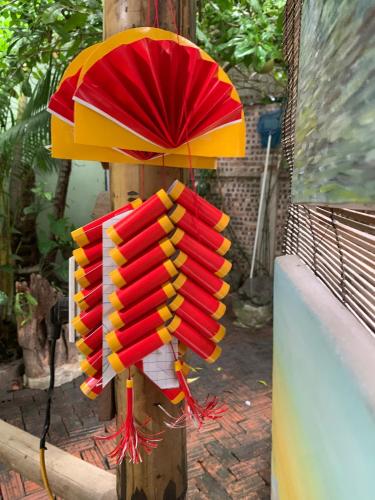 a bunch of red and yellow umbrellas on a pole at Nhà Lúa Homestay in Ninh Binh