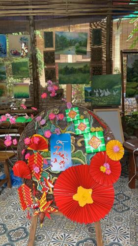 a group of red umbrellas sitting on a table at Nhà Lúa Homestay in Ninh Binh