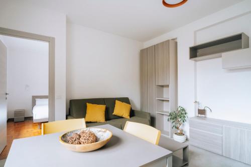 a living room with a table and a couch at Aosta Holiday Apartments - Monte Solarolo in Aosta