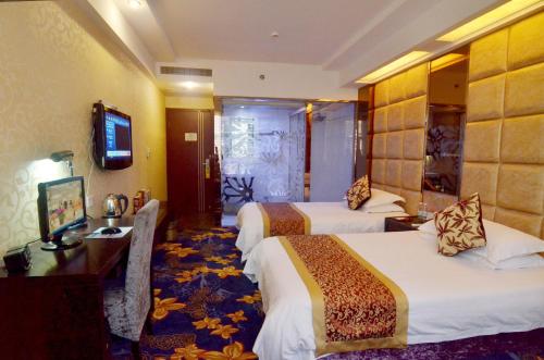 a hotel room with two beds and a television at Yiwu Yuejia Business Hotel in Yiwu