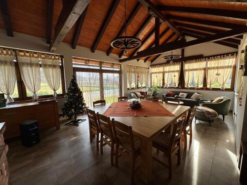 una gran sala de estar con una mesa y un árbol de Navidad en Ruralna kuca 'Villa Zagorka' za odmor sa bazenom i bočalištem, en Donja Pačetina