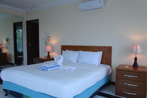 ein Schlafzimmer mit einem Bett mit einer blauen Schachtel darauf in der Unterkunft Villa Ebel in Lovina