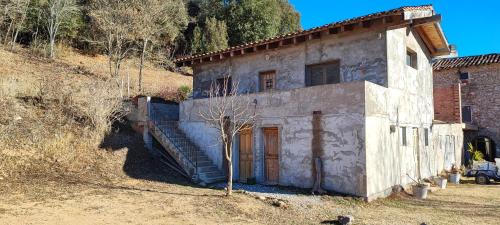 an old stone building with a tree in front of it at Anex les Corominotes in Olot