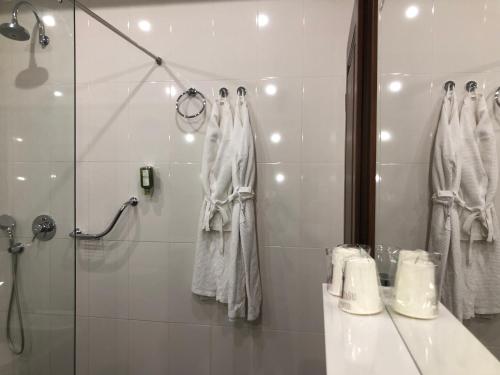 a bathroom with a shower and a sink and a mirror at Villa Anica Dubrovnik - luxurious with a sea view in Dubrovnik