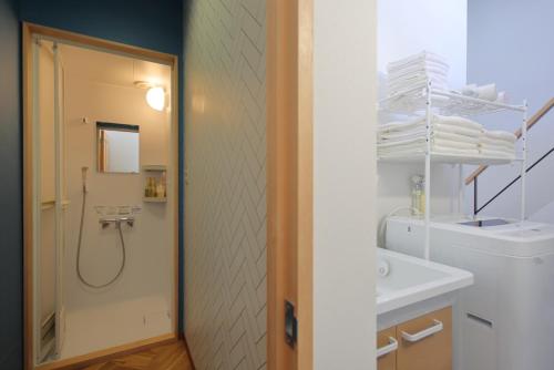 a bathroom with a shower and a sink at Glamping Dome YOSHIMURA in Fujikawaguchiko