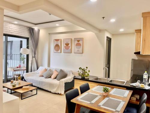 een woonkamer met een bank en een tafel bij Nice Masteri ThaoDien apt near Landmark 81 2brs in Ho Chi Minh-stad