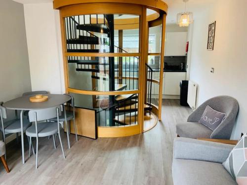 a living room with a spiral staircase and a table at Pass the Keys Stunning townhouse in uphill historic Lincoln in Lincoln