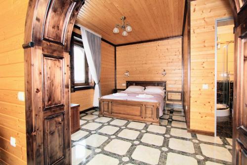 a bedroom with a bed in a wooden room at Бесаги in Yaremche