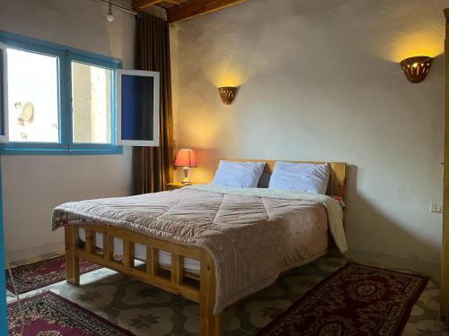 a bedroom with a large bed with a window at Nobian House Studios #1 in Luxor