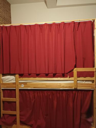 a pair of bunk beds in front of a red curtain at Global Guest Rooms in Sintra
