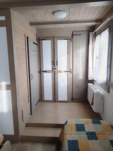 a room with two doors and a bed in it at LE CERQUE in Spoleto