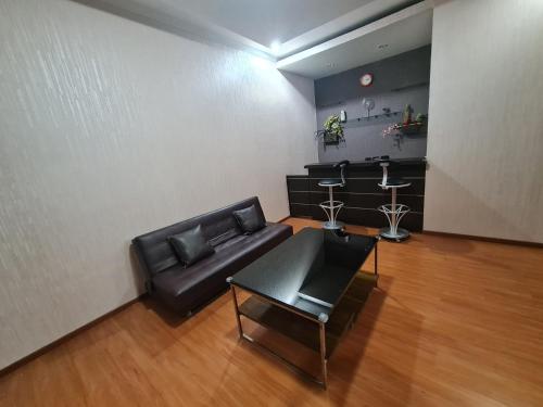 a living room with a couch and a table at Town House MGR 2, Central Park Mall Area, Pool Side-1st floor in Jakarta