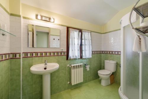 a bathroom with a sink and a toilet at El Mirador de Trasvia Comillas in Trasvia