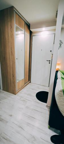 a room with a closet and a bed and a door at Apartament 43 in Płock