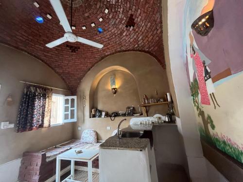 a kitchen with a ceiling with a brick wall at Nobian House Studios #2 in Luxor