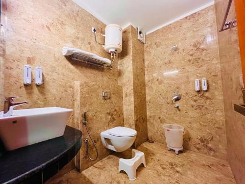 a bathroom with a sink and a toilet in it at The Nature Valley View Resort, Mussoorie in Mussoorie