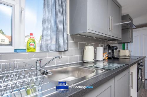 a kitchen counter with a sink and a window at One Bedroom Apartment By Beds Away Short Lets & Serviced Accommodation in North Oxford With Free Wifi in Oxford
