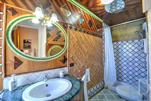 a bathroom with a sink and a mirror and a toilet at Villa Costa degli Dei in Furore