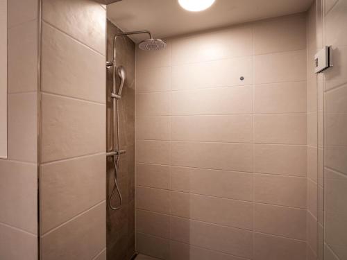 a shower with a glass door in a bathroom at Alpine Homes - Hopfgarten in Hopfgarten im Brixental