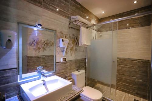 LUSINDA HOTEL MANAGEMENT BY ZAD في السويس: حمام مع حوض ومرحاض
