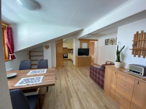 a living room with a table and a couch at Haus Latschenheim in Ramsau am Dachstein