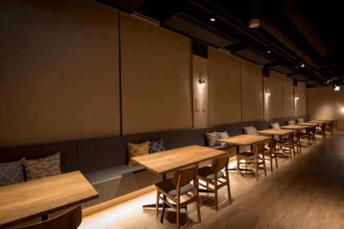 a row of tables and chairs in a room at Ashibetsu Onsen Starlight Hotel in Ashibetsu