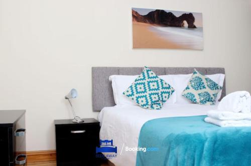 a bedroom with a bed with blue and white pillows at 3 Bedroom House For Contractors By Beds Away Short Lets & Serviced Accommodation Oxford With Free Parking for 2 Cars in Oxford