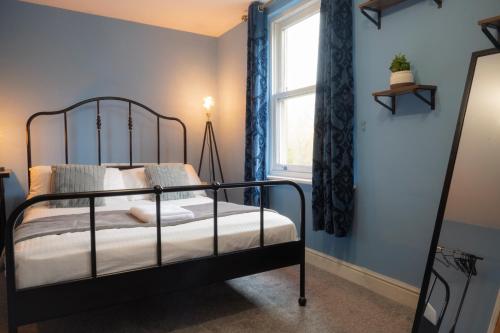 a bedroom with a bed and a window at Spacious 2 bed apartment in Canterbury