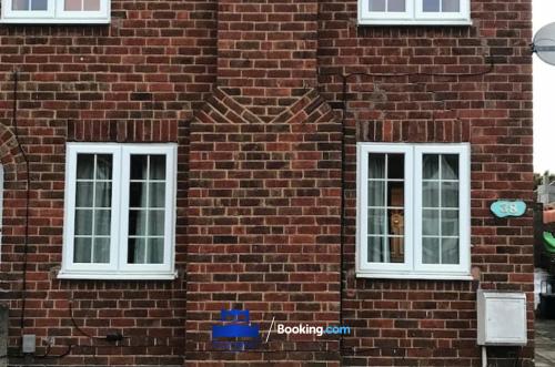 two windows on the side of a brick building at 3 Bedroom House For Contractors By Beds Away Short Lets & Serviced Accommodation Oxford With Free Parking for 2 Cars in Oxford