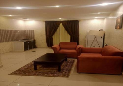 a living room with two couches and a coffee table at حياة ريف للوحدات السكنية المفروشة in Jeddah