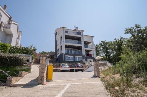 a building with a car parked in front of it at Luxury Spa Apartment Luna in Njivice