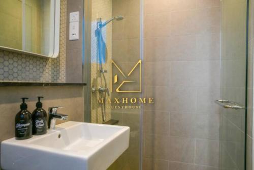 a bathroom with a sink and a shower with a mirror at Maxhome Plus at Lucentia Bukit Bintang City centre KL in Kuala Lumpur