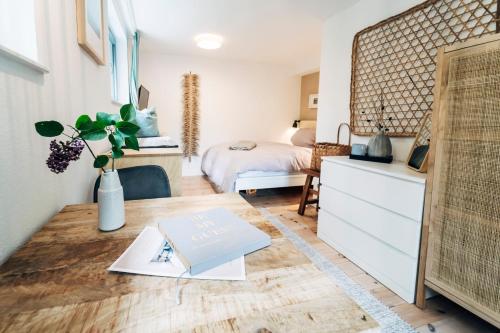 Dormitorio con cama y escritorio con libro en Urlaub an der Flensburger Förde mit Sauna & schönem Ambiente, en Flensburg