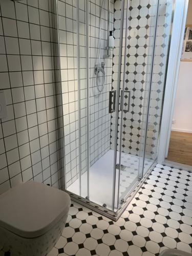 a shower stall in a bathroom with a toilet at Via Pia 29-7 in Savona