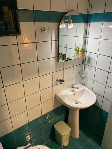 a bathroom with a sink and a toilet at Golden Star in Nydri
