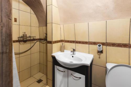 a bathroom with a sink and a shower at Apartmány na Trojici - DOLNÝ apartmán in Banská Štiavnica